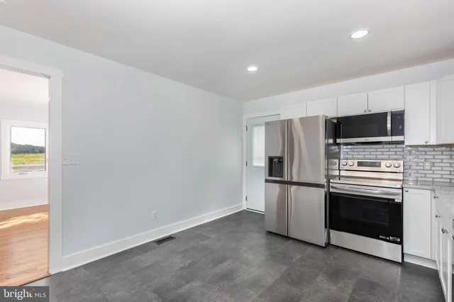 a kitchen with a refrigerator stove and microwave