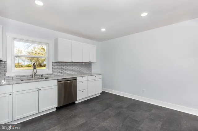 a kitchen with sink and cabinets