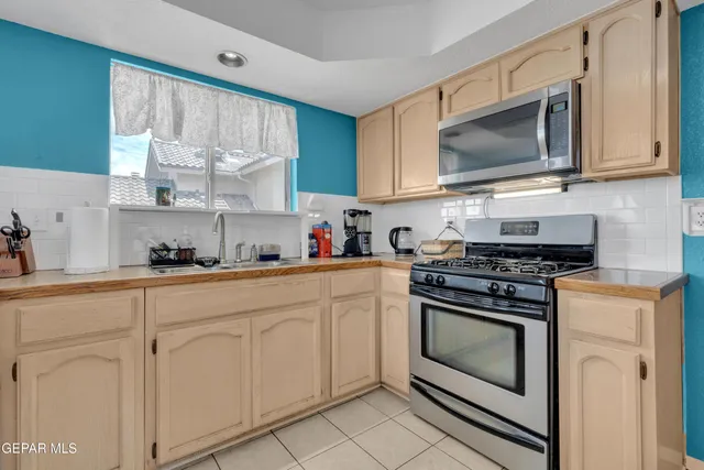 a kitchen with white cabinets stainless steel appliances and sink
