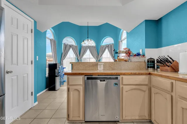 a view of cabinets a sink and a wooden floor in a kitchen