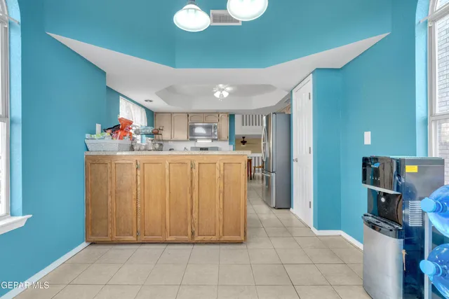 a room with a washing machine and a chair