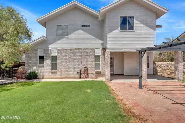 a view of a house with a backyard and a garden
