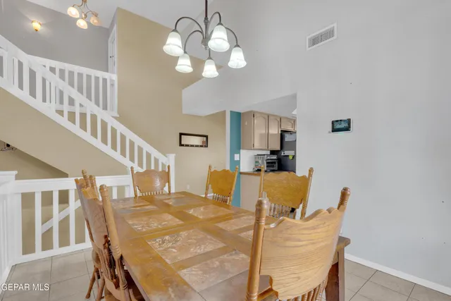 a dining room with furniture and chandelier