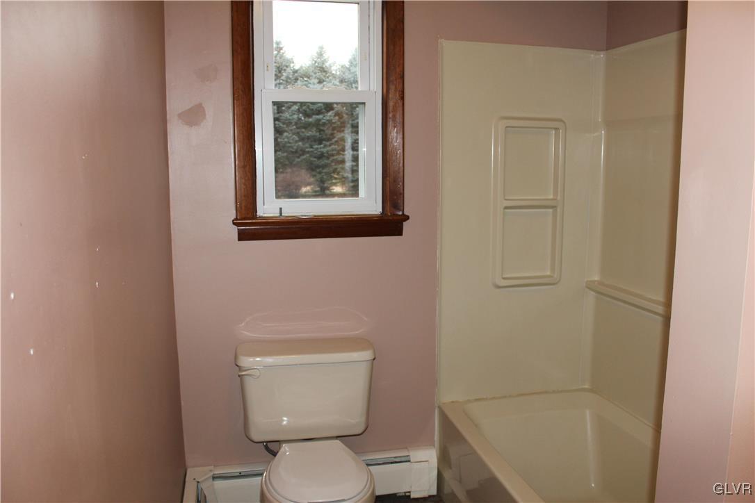 1227 Clearfield Road Nazareth, PA 18064 - Photo 5 of 18 a white toilet sitting next to a bathroom sink and tub