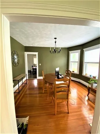 a living room with fireplace furniture and a large window
