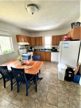 a kitchen with a dining table and chairs