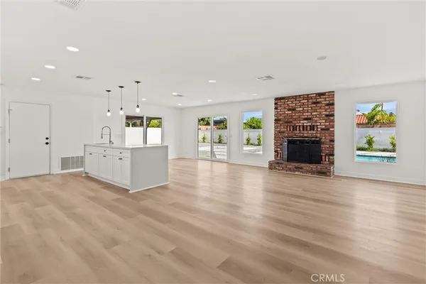 an empty room with furniture and fireplace