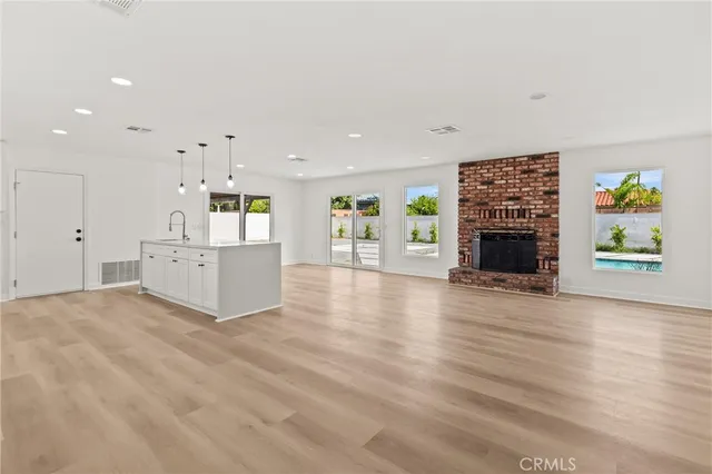 an empty room with furniture and fireplace