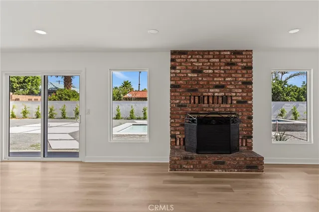 a living room with fireplace furniture and a window