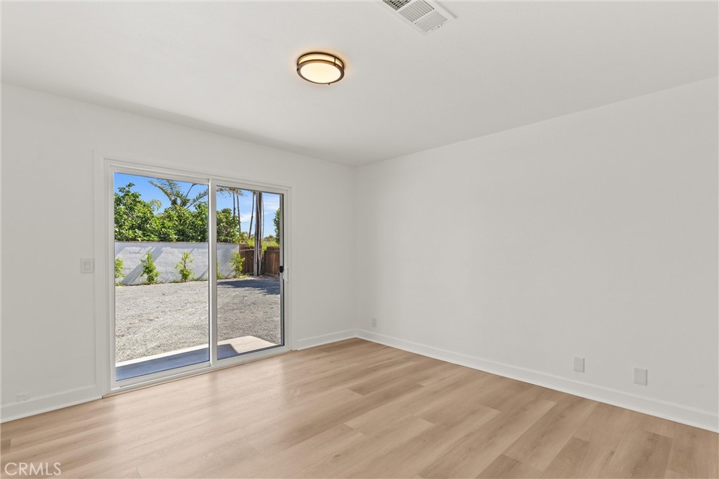 2852 East San Angelo Road Palm Springs, CA 92262 - Photo 16 of 25 an empty room with wooden floor and windows
