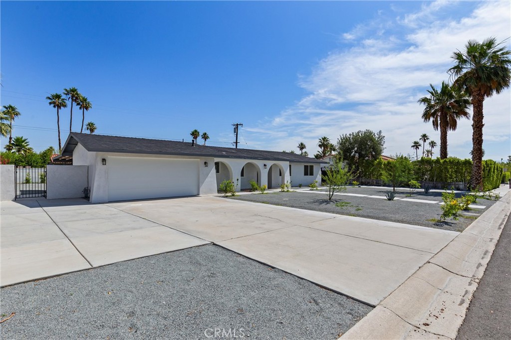 2852 East San Angelo Road Palm Springs, CA 92262 - Photo 2 of 25 a view of a street with a building and palm trees