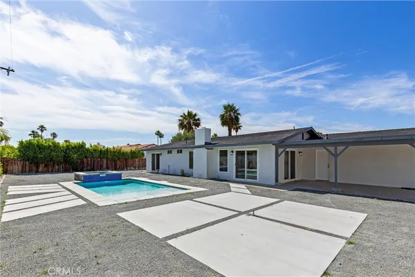 a view of a house with a backyard