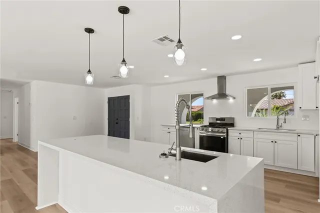 a kitchen with stainless steel appliances kitchen island a large island in the center