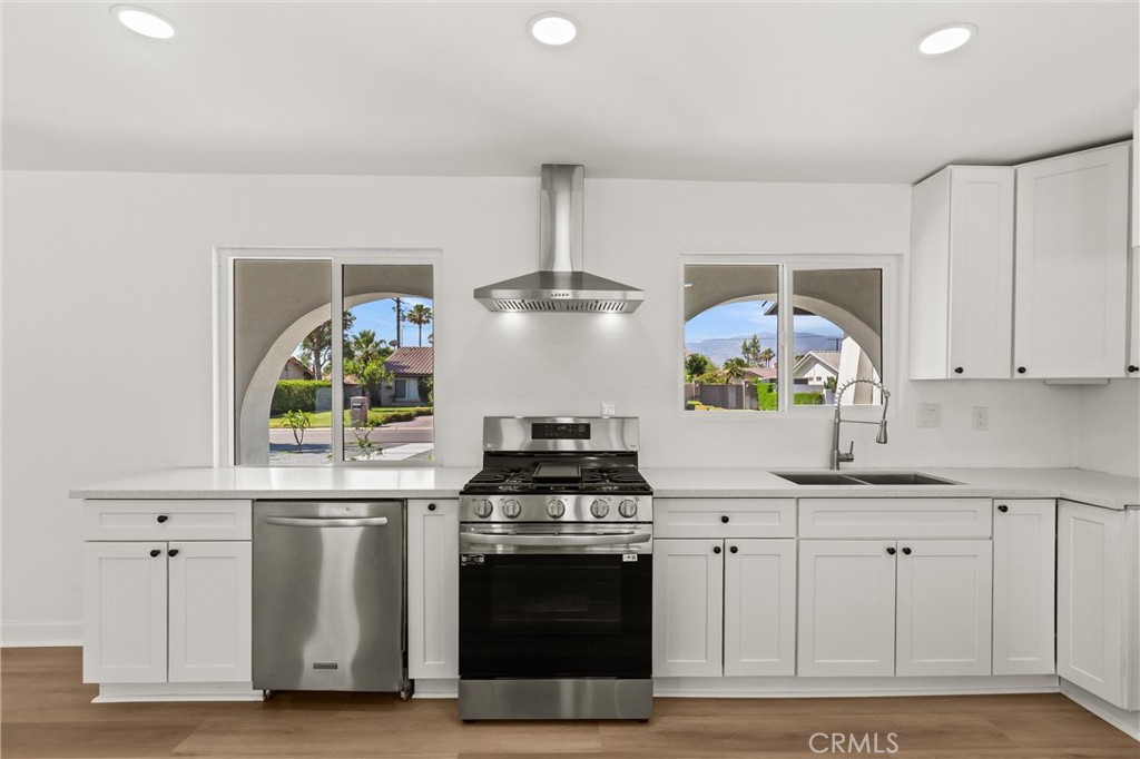 2852 East San Angelo Road Palm Springs, CA 92262 - Photo 8 of 25 a kitchen with white cabinets and appliances