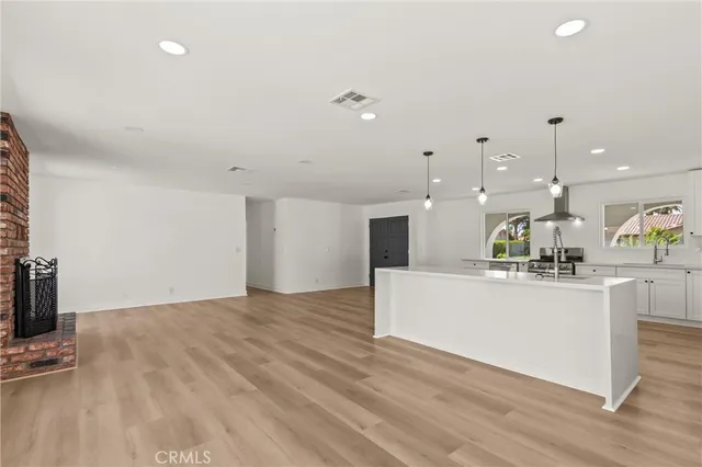 a view of kitchen with kitchen island microwave and stove