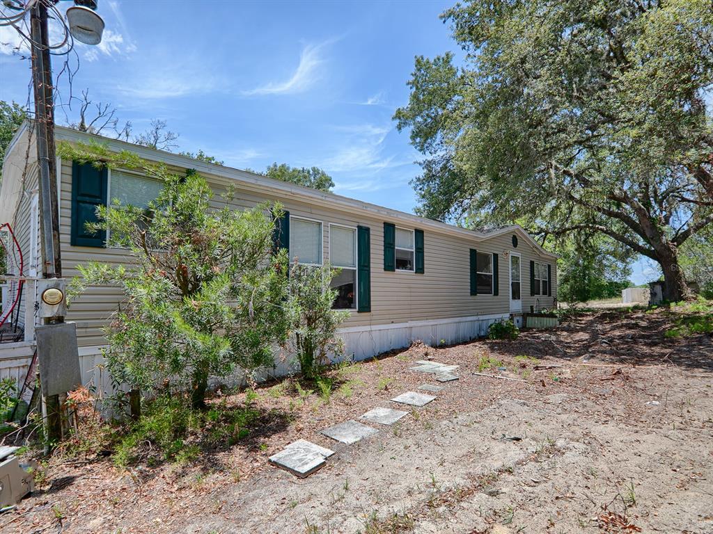 22516 Curle Road Eustis, FL 32736 - Photo 1 of 1 a view of a house with a yard
