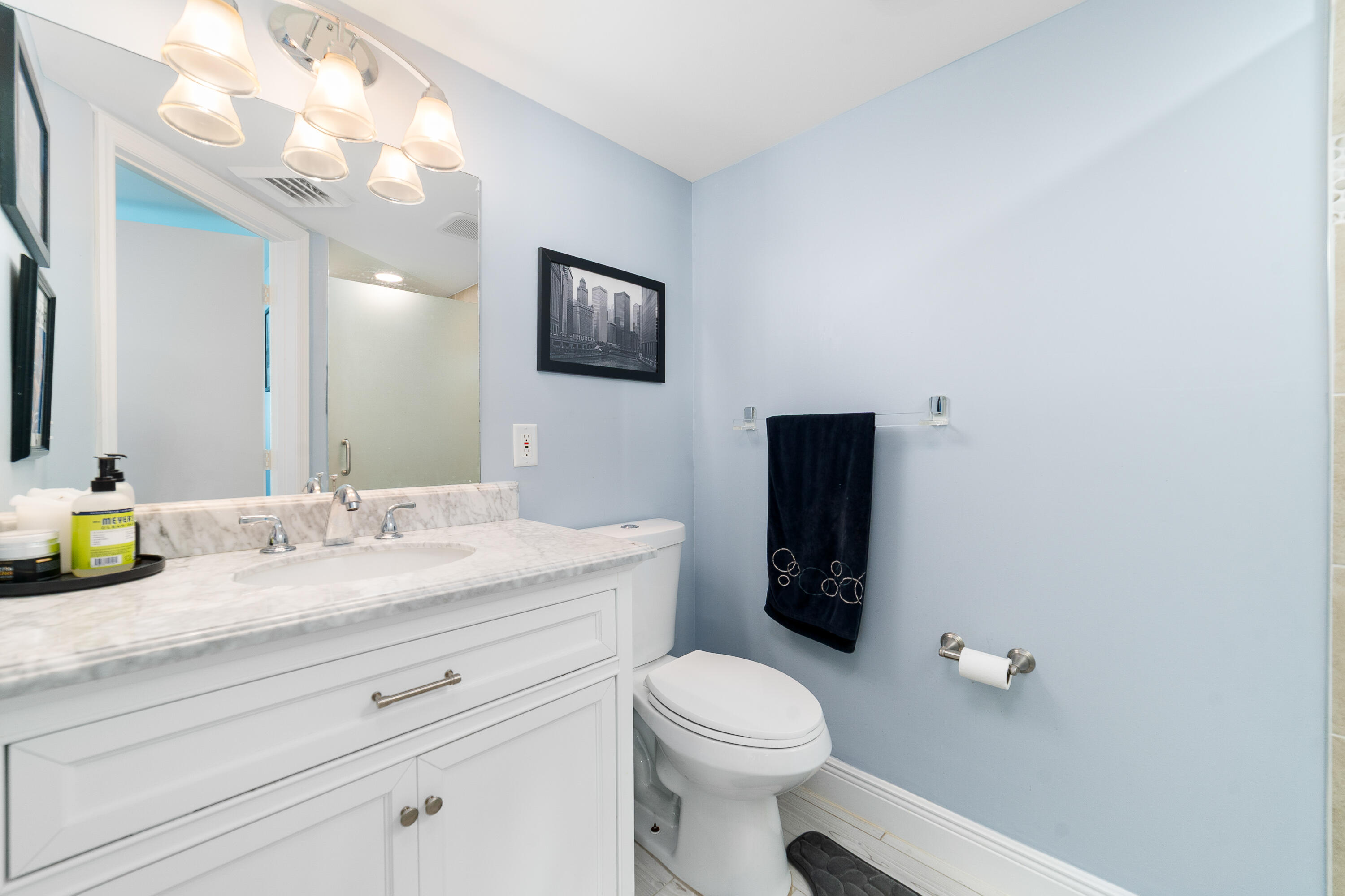 8800 South Ocean Drive, Unit 1102 Jensen Beach, FL 34957 - Photo 15 of 39 a bathroom with a granite countertop sink vanity mirror and toilet
