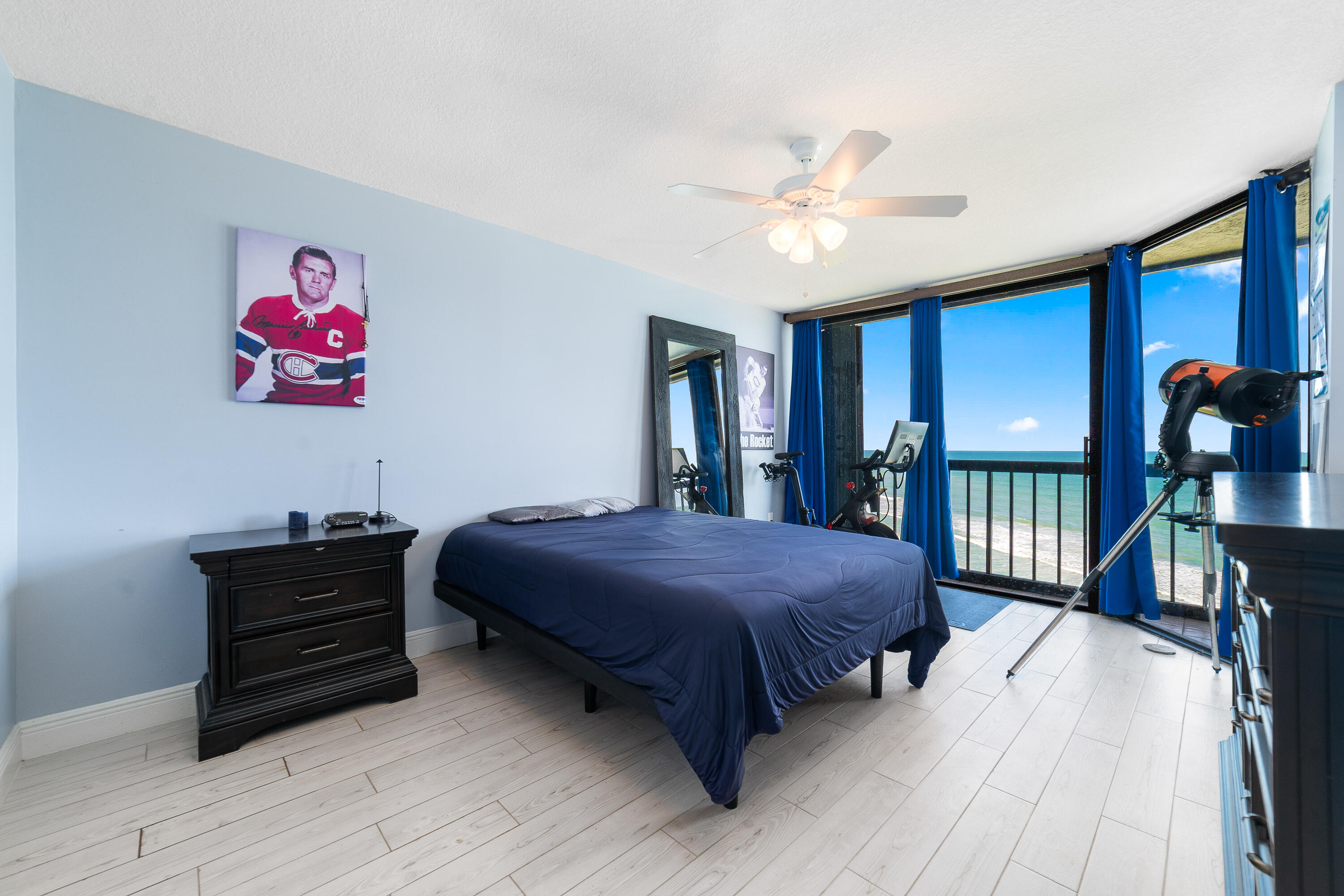 8800 South Ocean Drive, Unit 1102 Jensen Beach, FL 34957 - Photo 17 of 39 a bedroom with a bed and a chandelier