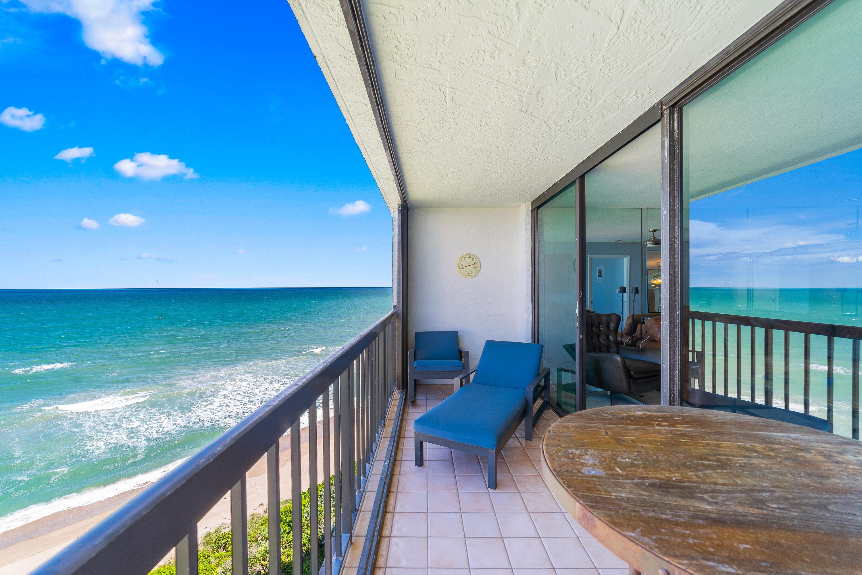 8800 South Ocean Drive, Unit 1102 Jensen Beach, FL 34957 - Photo 19 of 39 a view of a balcony with chair and wooden floor