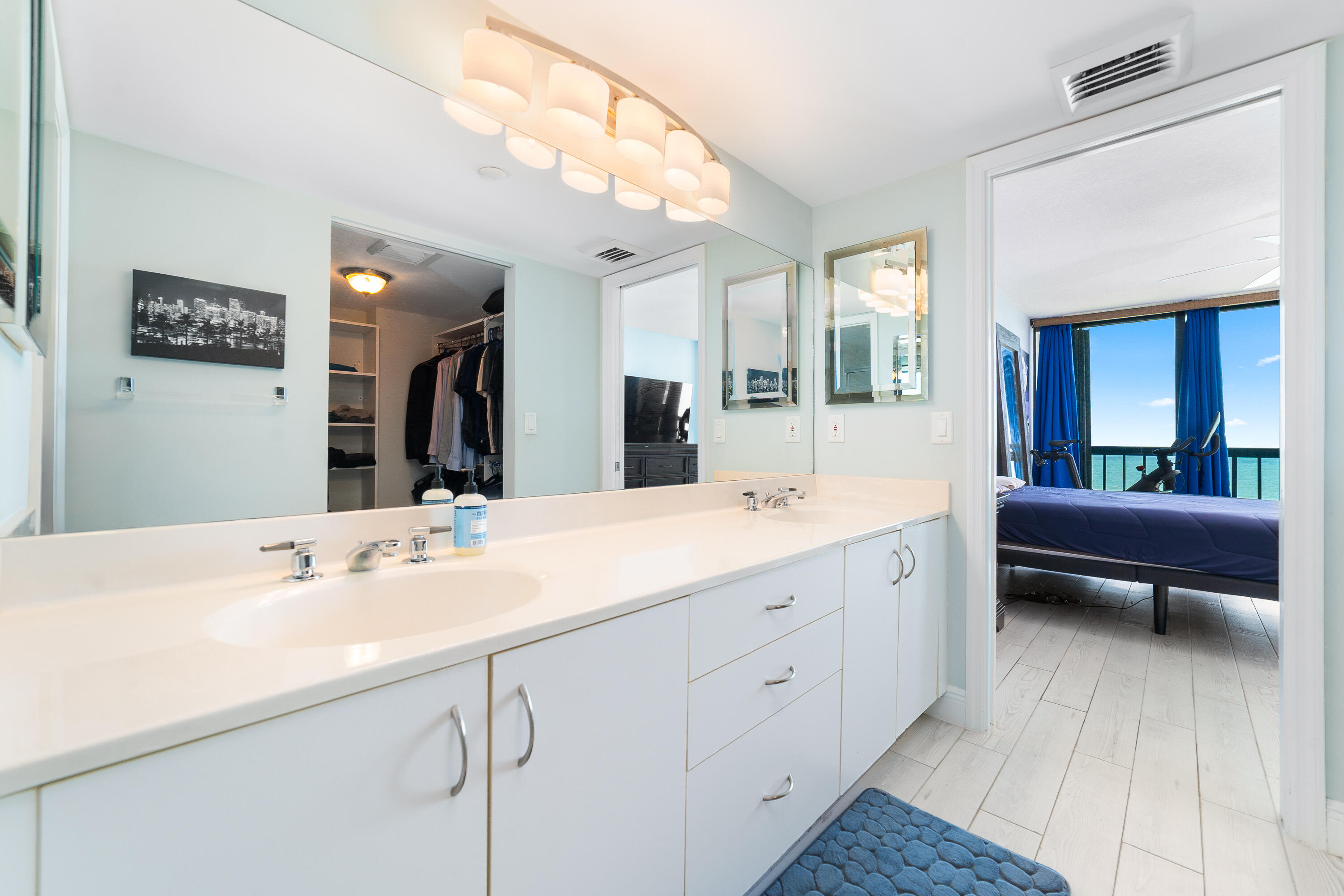 8800 South Ocean Drive, Unit 1102 Jensen Beach, FL 34957 - Photo 21 of 39 a spacious bathroom with a double vanity sink a mirror and a bathtub