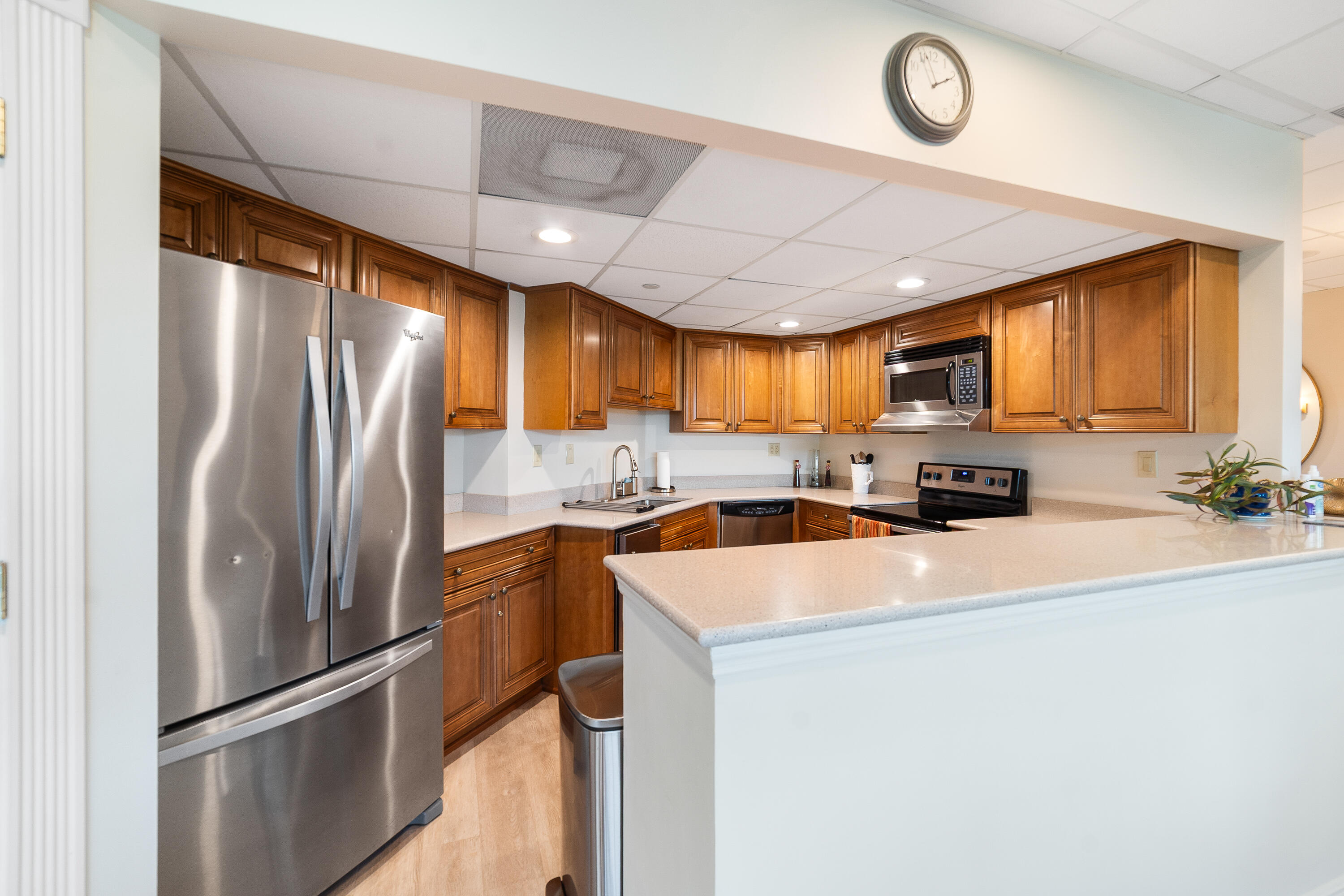 8800 South Ocean Drive, Unit 1102 Jensen Beach, FL 34957 - Photo 30 of 39 a kitchen with stainless steel appliances granite countertop a refrigerator a stove a sink and a refrigerator