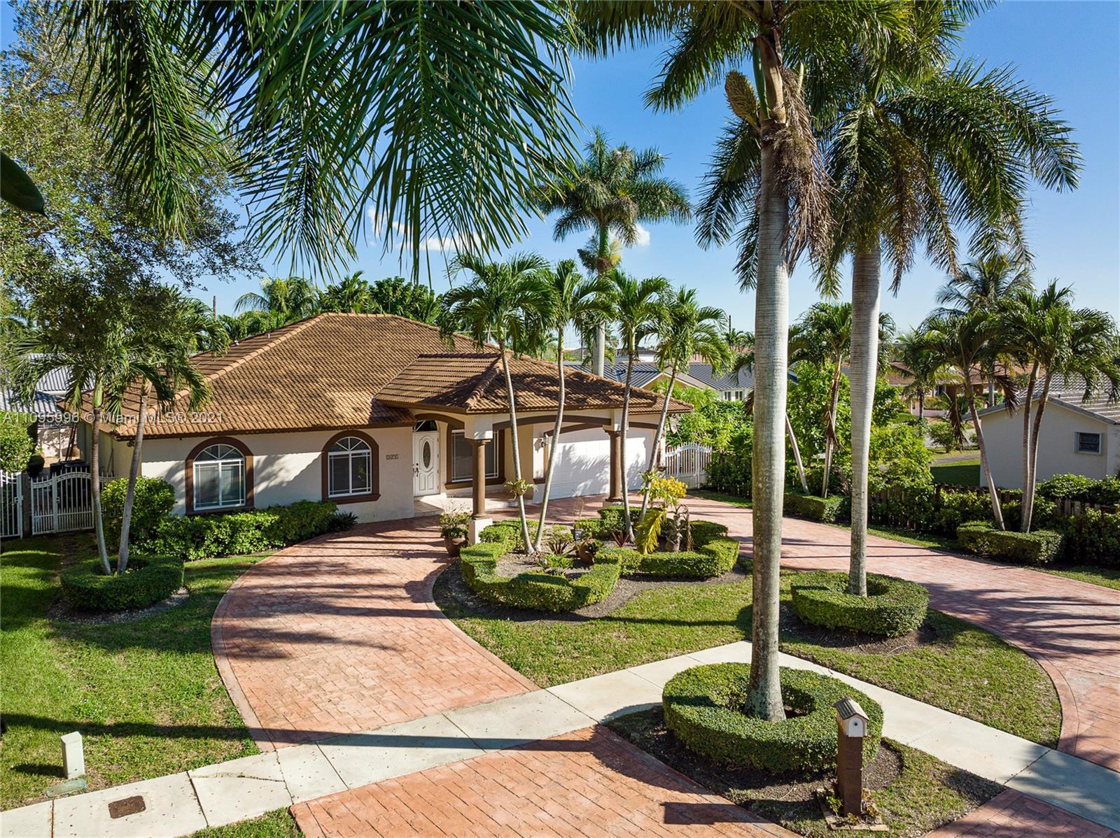 3671 Southwest 139th Court Miami, FL 33175 - Photo 1 of 56 a front view of a house with garden and trees