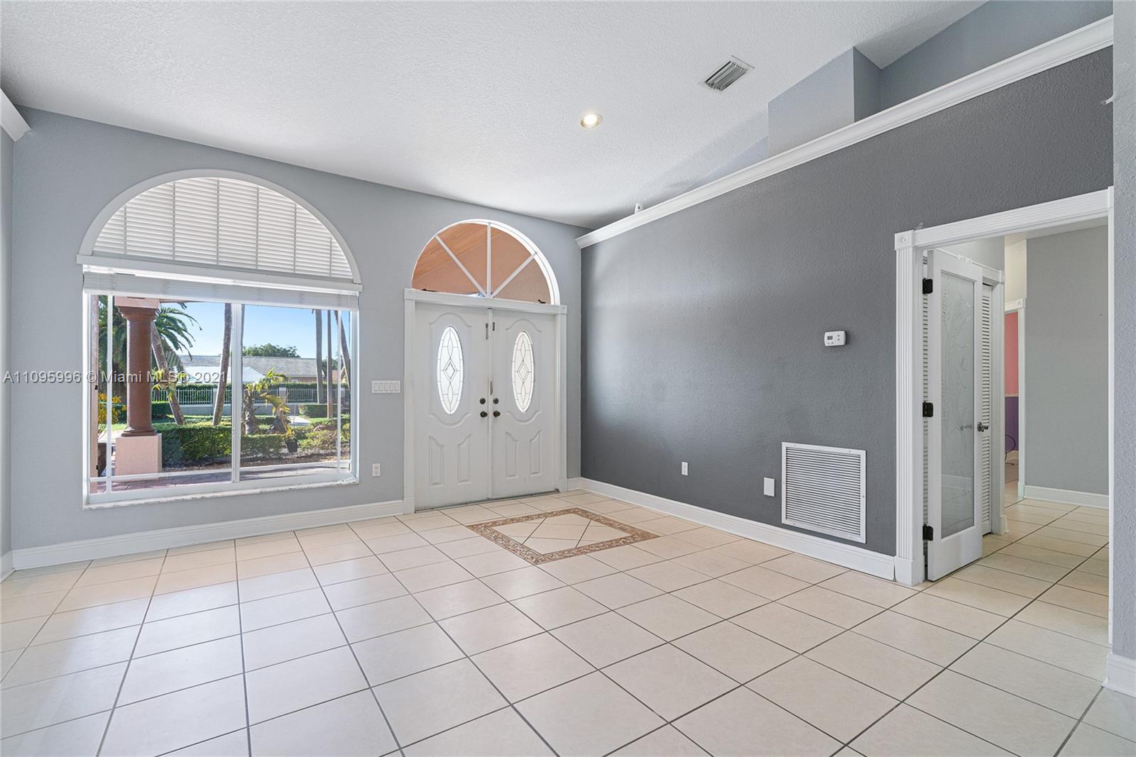 3671 Southwest 139th Court Miami, FL 33175 - Photo 12 of 56 wooden floor in an empty room with a window