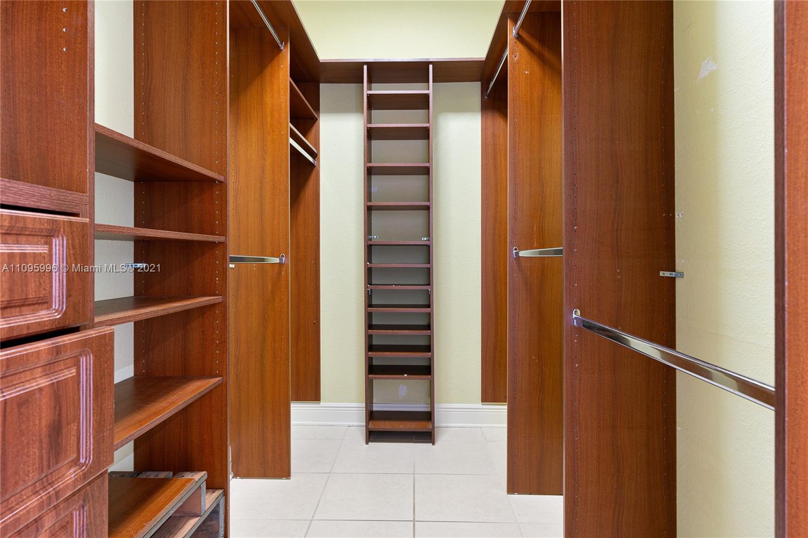 3671 Southwest 139th Court Miami, FL 33175 - Photo 22 of 56 a view of walk in closet with empty racks