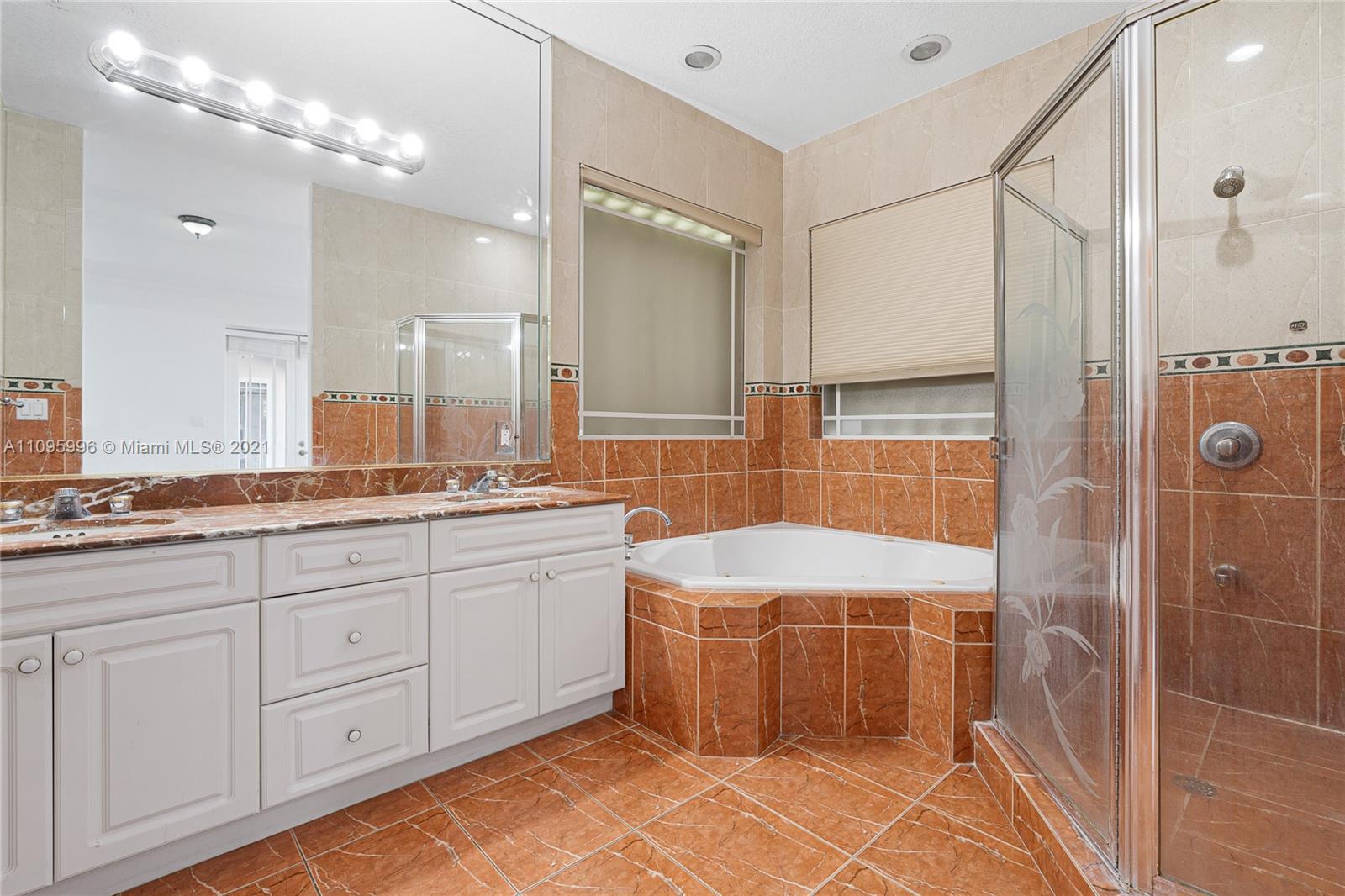 3671 Southwest 139th Court Miami, FL 33175 - Photo 24 of 56 a bathroom with a double vanity sink a mirror and a shower