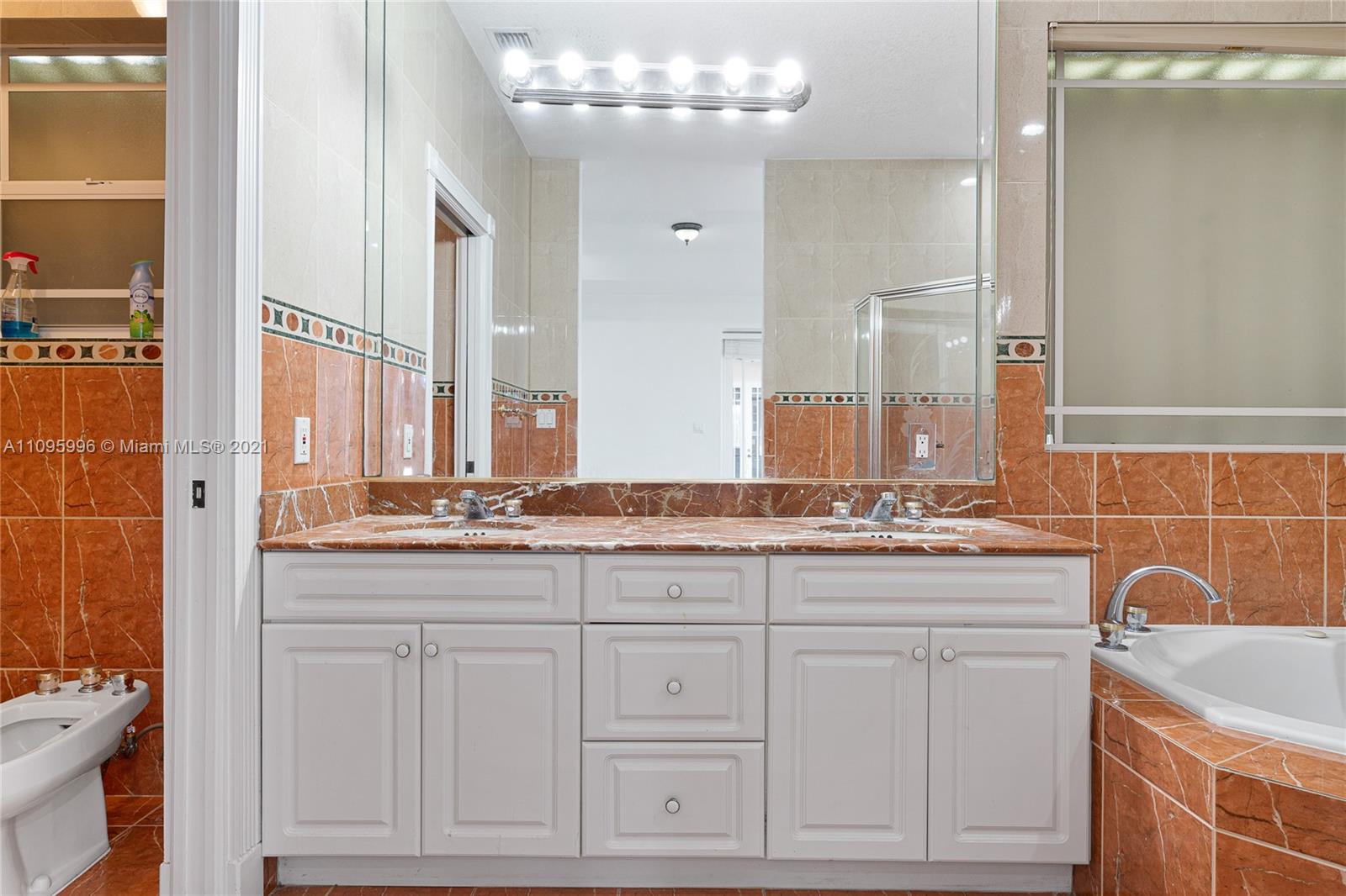 3671 Southwest 139th Court Miami, FL 33175 - Photo 25 of 56 a bathroom with double sink and a mirror