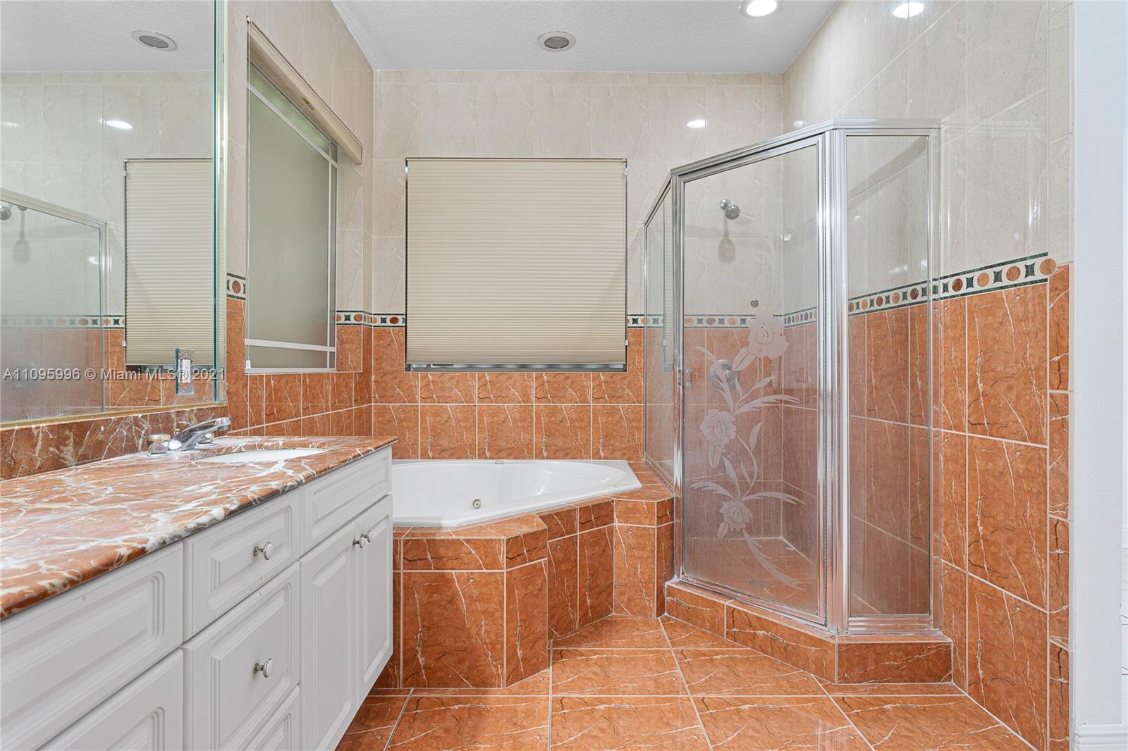 3671 Southwest 139th Court Miami, FL 33175 - Photo 26 of 56 a bathroom with a granite countertop sink a mirror and a bathtub