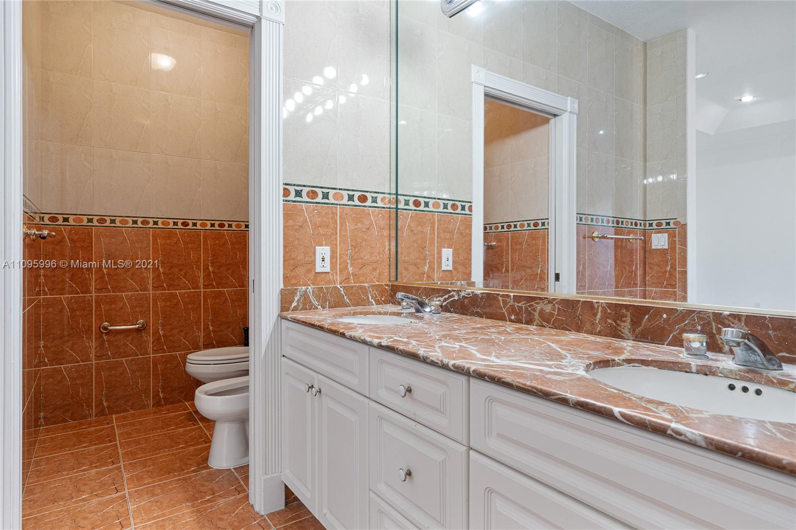 3671 Southwest 139th Court Miami, FL 33175 - Photo 27 of 56 a bathroom with a granite countertop sink a toilet and a mirror