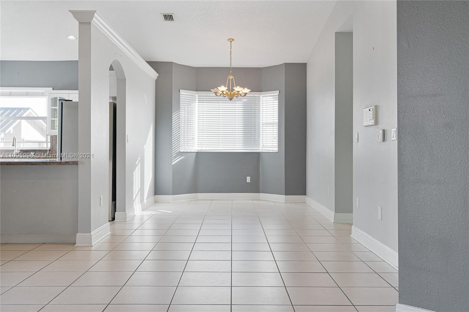 3671 Southwest 139th Court Miami, FL 33175 - Photo 31 of 56 a view of an empty room with window and chandelier