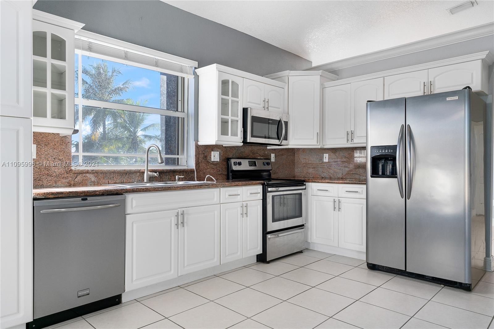3671 Southwest 139th Court Miami, FL 33175 - Photo 41 of 56 a kitchen with stainless steel appliances granite countertop a refrigerator and a sink