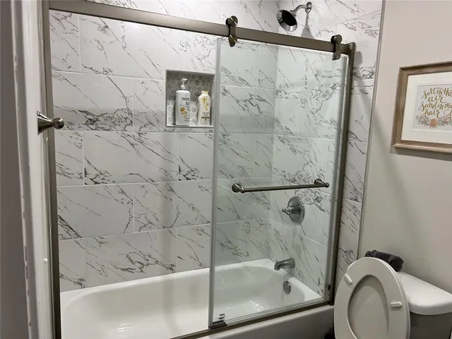 a bathroom with a shower and toilet