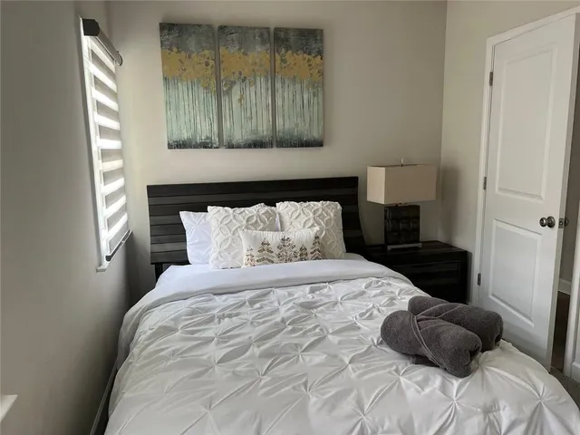 a bedroom with a bed and a window