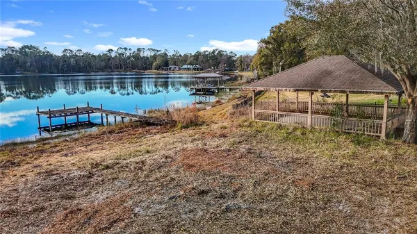 a view of a lake in between two and trees