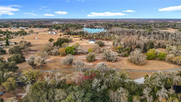 an aerial view of a house with a lake view