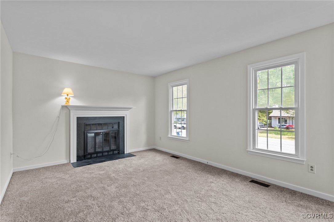 Unfurnished living room with baseboards, a healthy