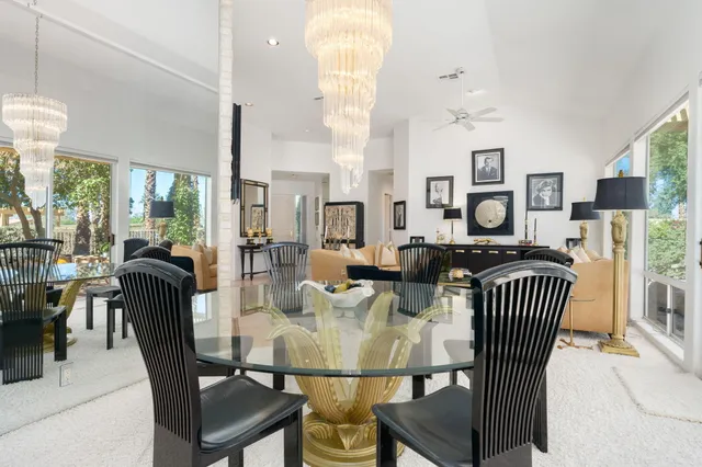 a living room with lots of furniture and kitchen view