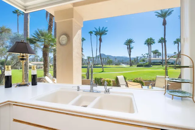 a view of a patio with furniture and a yard