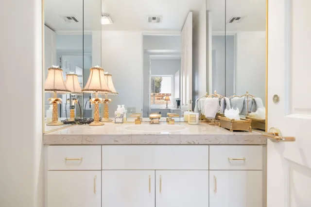 a bedroom with a bed and a potted plant on the dresser