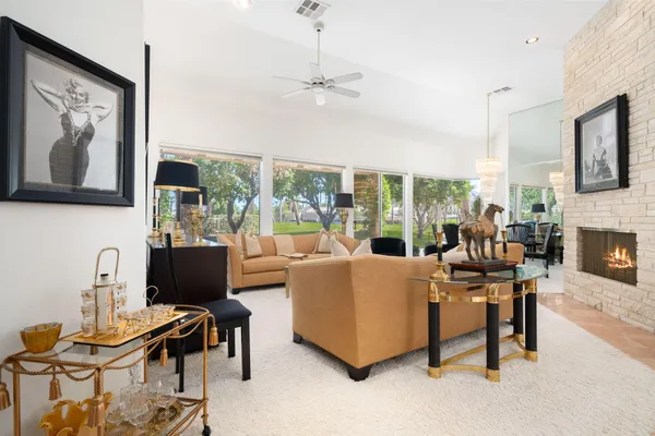 a dining room with furniture a flat screen tv and a large window