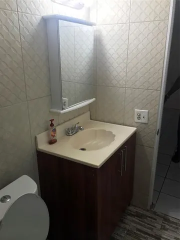 a bathroom with a sink toilet and vanity