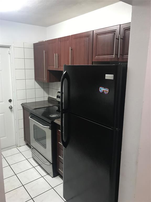 161 Northwest 164th Street, Unit 3 Miami, FL 33169 - Photo 5 of 8 a kitchen with a sink and a stove top oven