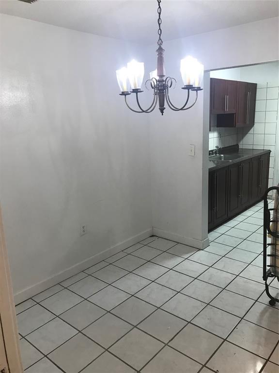 161 Northwest 164th Street, Unit 3 Miami, FL 33169 - Photo 7 of 8 a view of a room with wooden floor and cabinets
