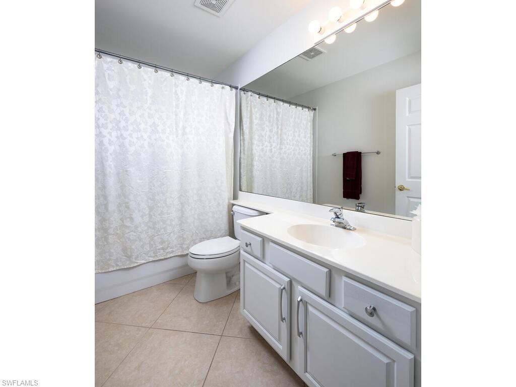 8846 Ventura Drive Naples, FL 34109 - Photo 12 of 18 a bathroom with a sink a toilet and mirror