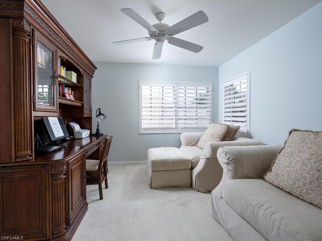 8846 Ventura Drive Naples, FL 34109 - Photo 13 of 18 a living room with furniture a desk and a window