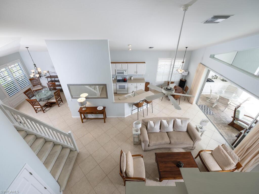 8846 Ventura Drive Naples, FL 34109 - Photo 6 of 18 a living room with furniture and a chandelier