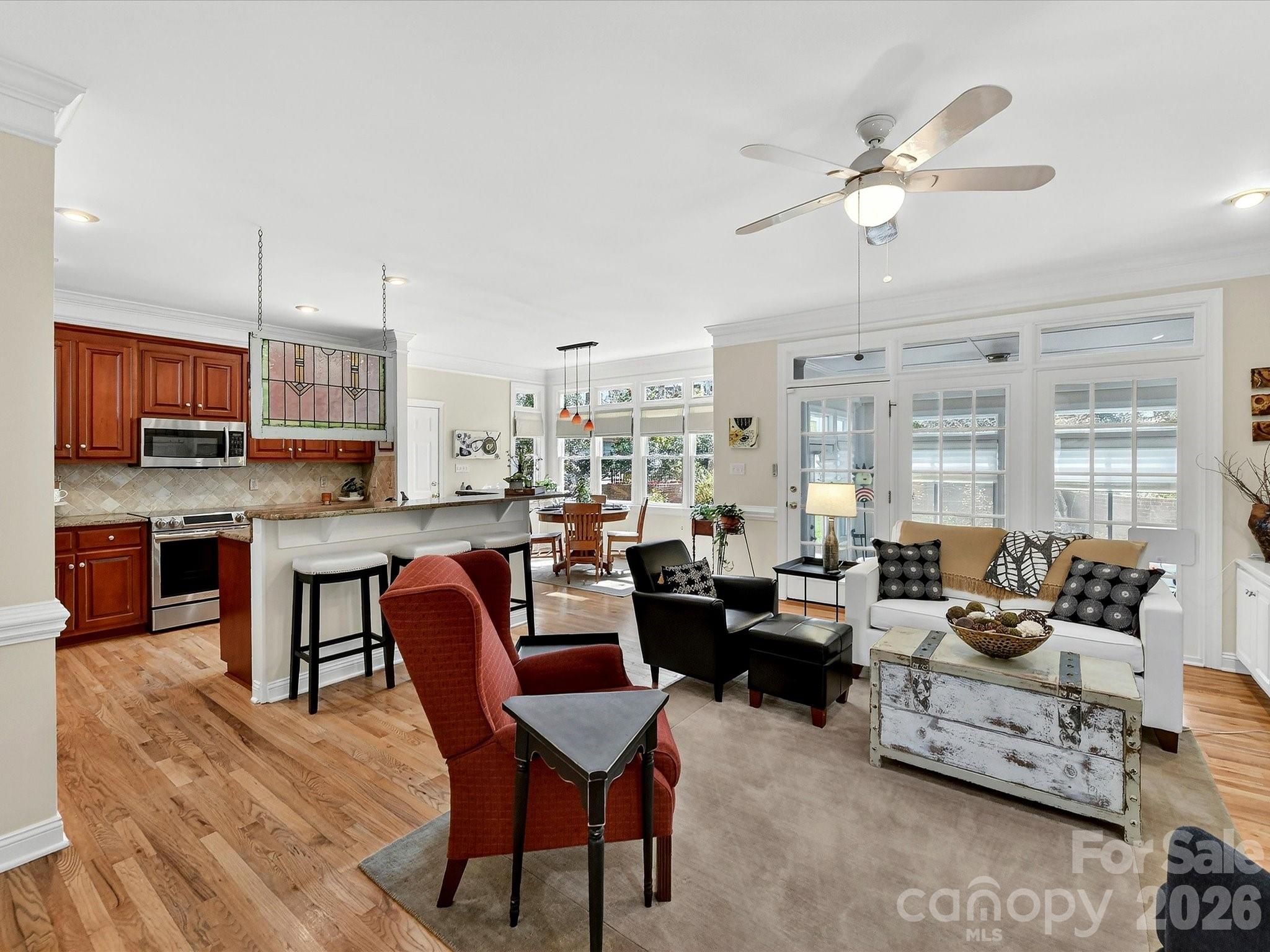 207 Hobbs Street Davidson, NC 28036 - Photo 11 of 40 a living room with fireplace furniture and a wooden floor